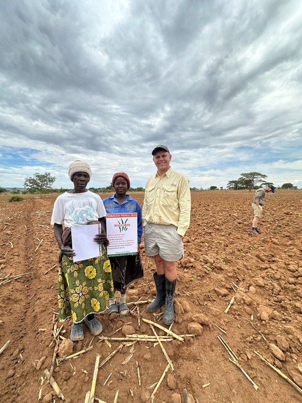 The grower and leaf tech with the trial sign on planting day